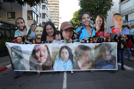 Families of hostages held by Hamas in Gaza and their supporters carry pictures of the hostages