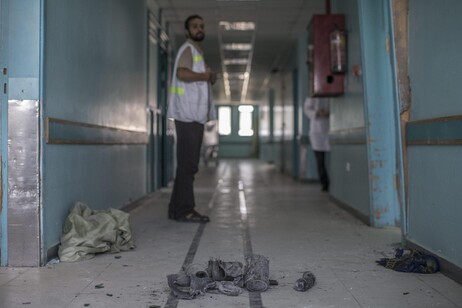 A staff member of the Al Wafa hospital in east Gaza City looks at the ruins